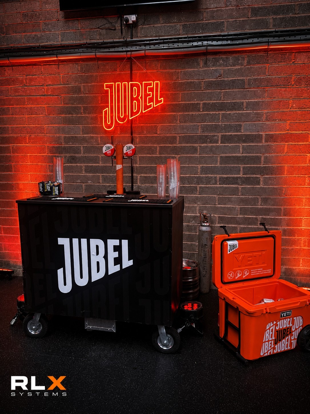 Branded mobile bar under neon signage with red wash lighting